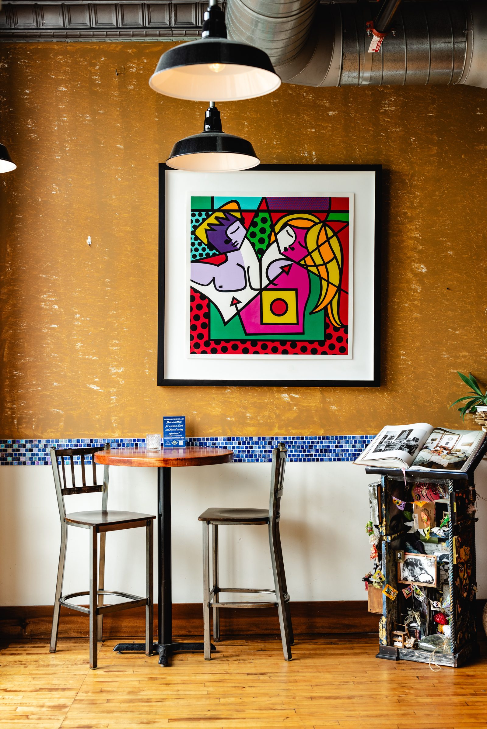 Gold walls, artwork and dining tables inside MeXo